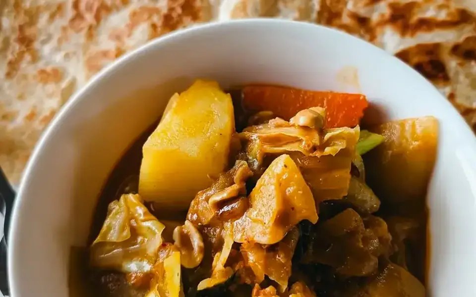 Gomen wat with lentils, spinach, and injera